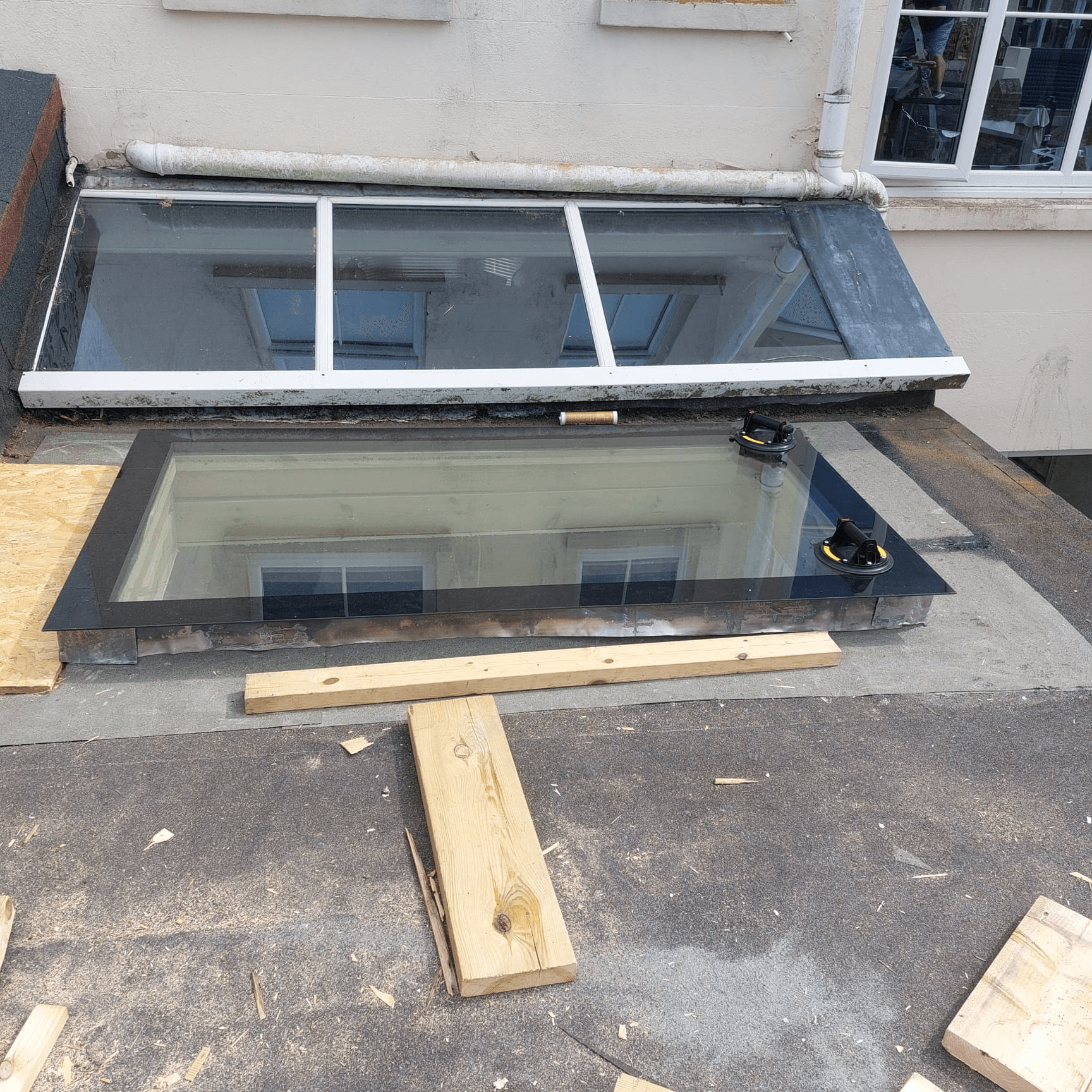 Tradesman fitting a window frame during home renovation